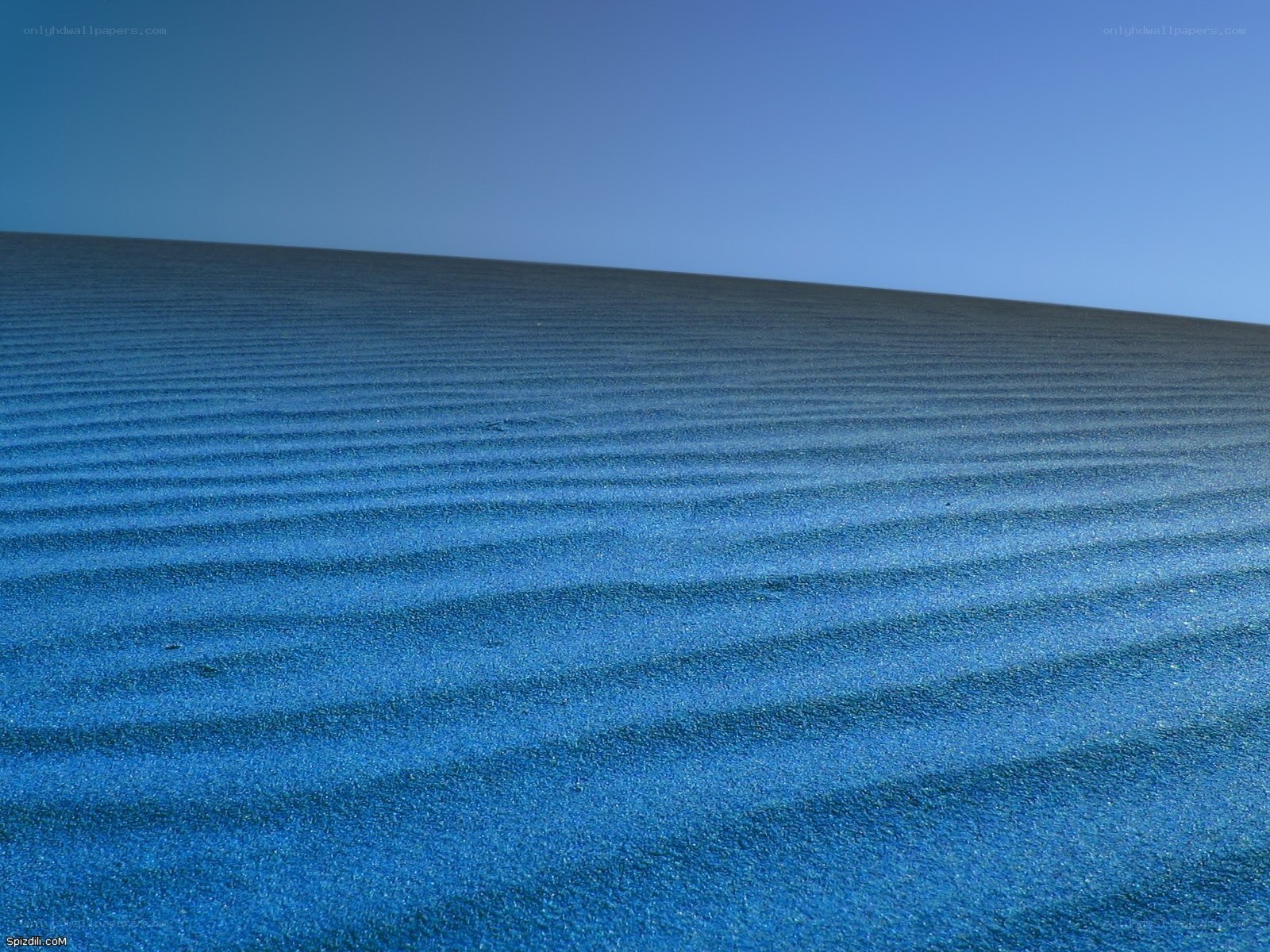 Blue sand dunes under clear sky