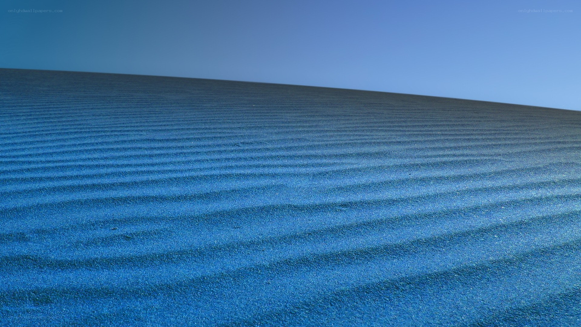 blue sand dunes under clear sky