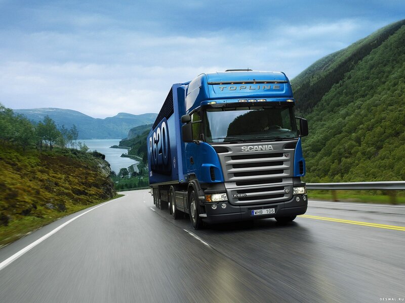 Blue Scania truck on a scenic road