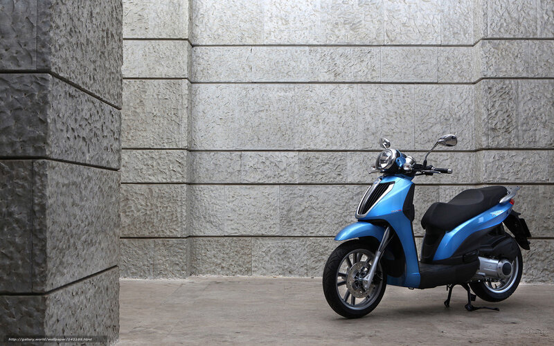 Blue scooter against stone wall