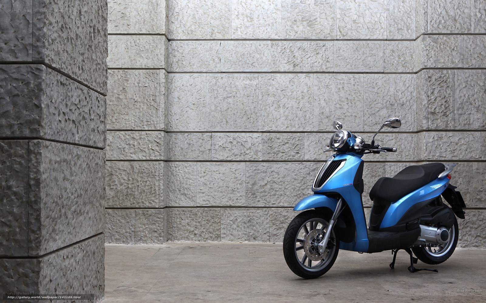 Blue scooter against stone wall