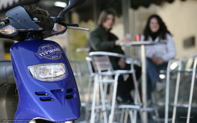 Blue scooter at outdoor cafe