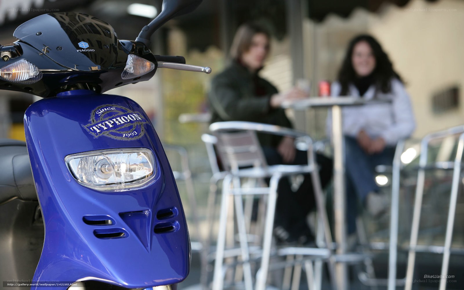 Blue scooter at outdoor cafe