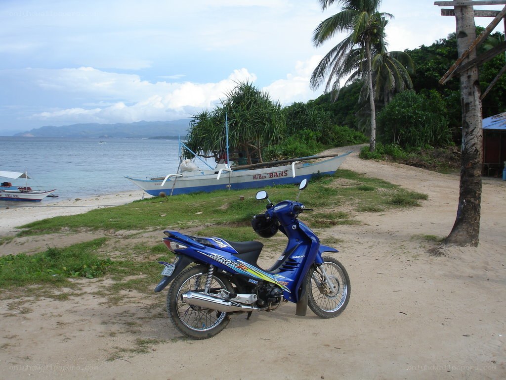 Blue scooter on a tropical beach