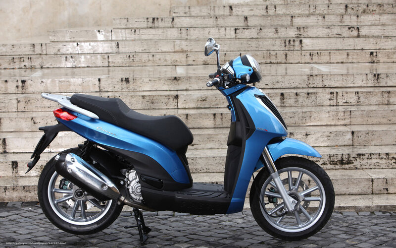 Blue scooter on cobblestones