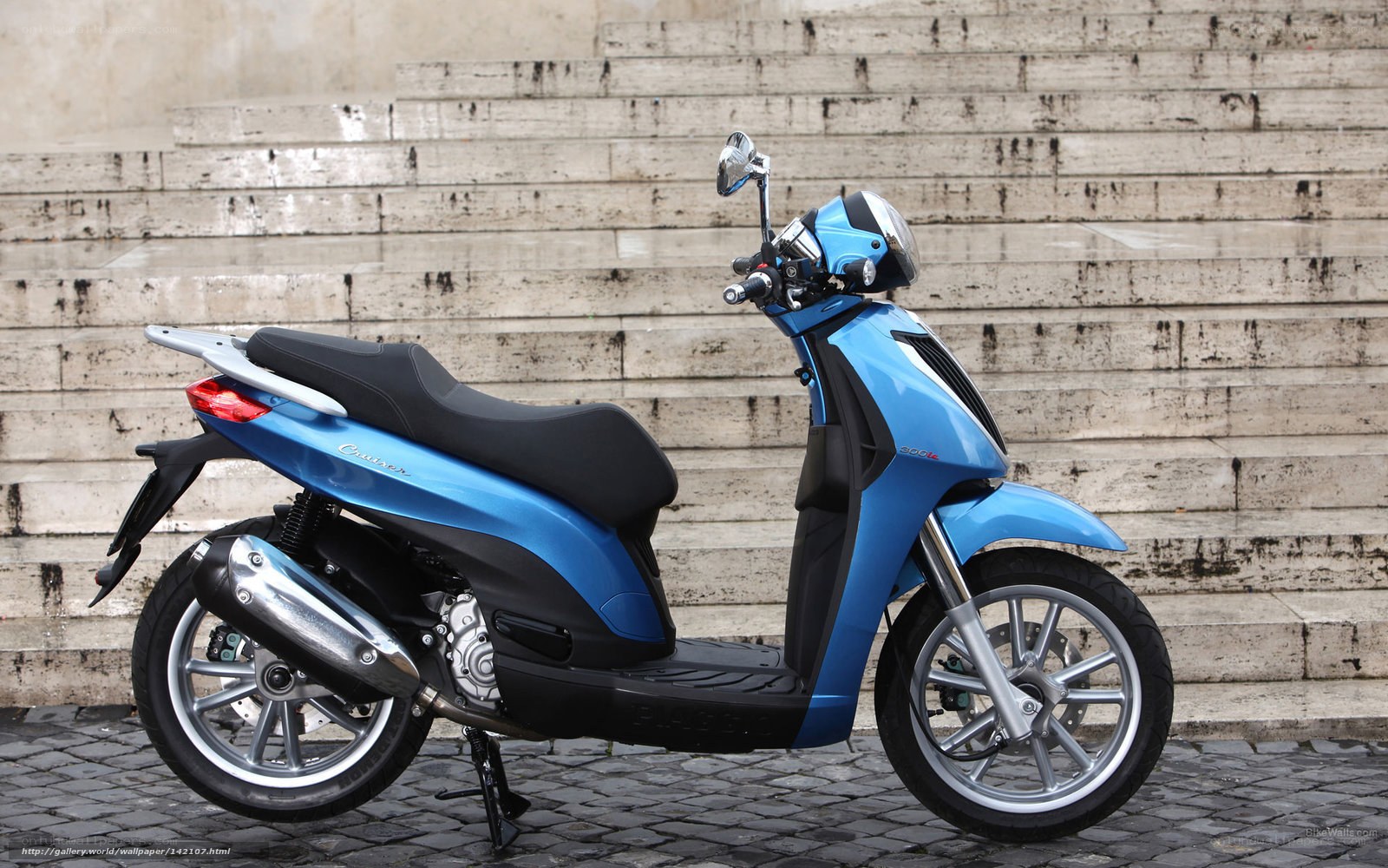 Blue scooter on cobblestones