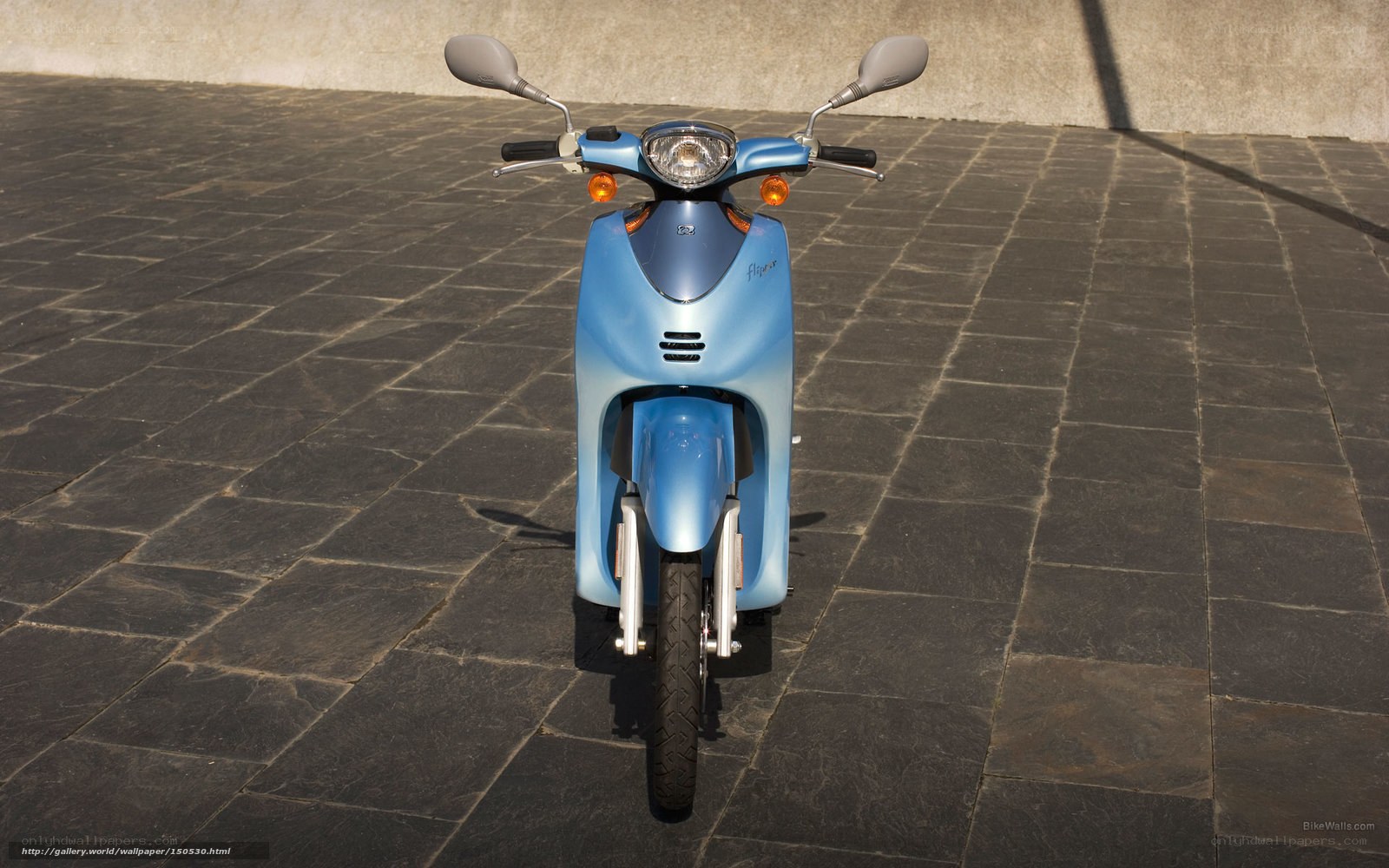 blue scooter on stone pavement
