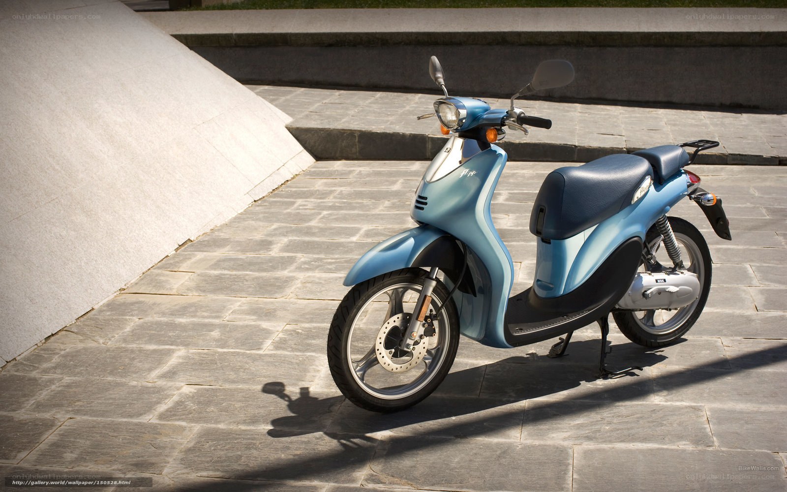 Blue scooter on stone pavement