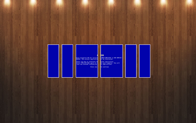 Blue screens on wood wall