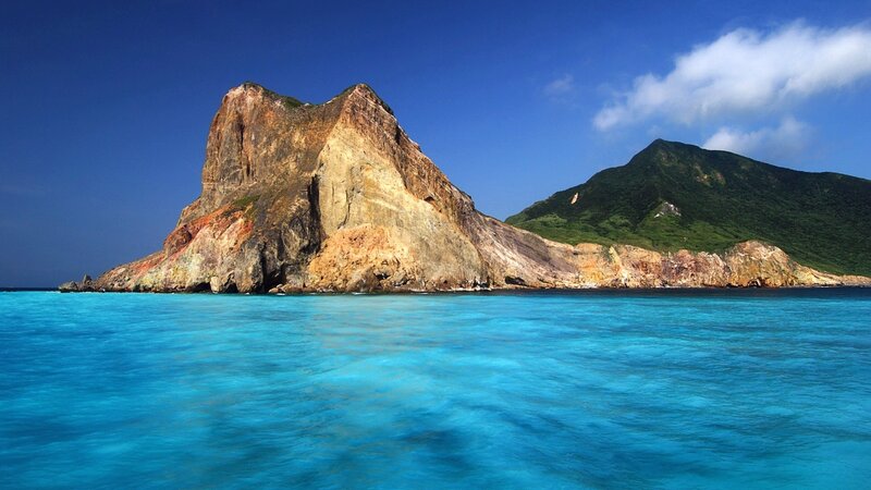 Blue sea with rocky island