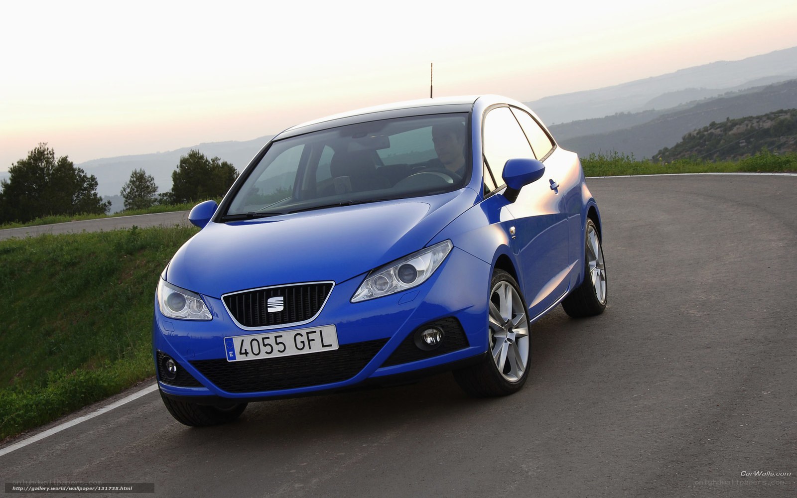 blue seat car on winding road