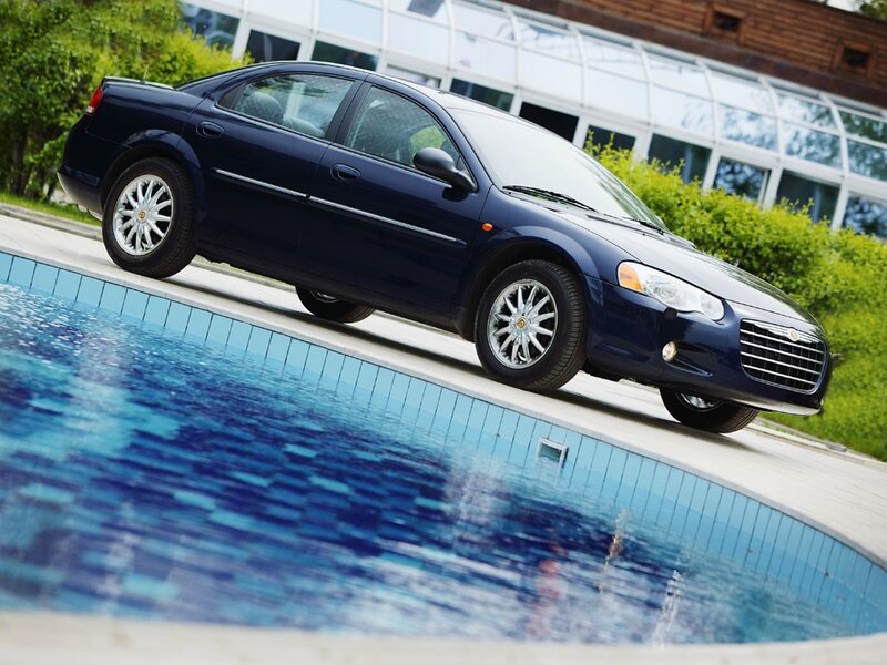 blue sedan by poolside