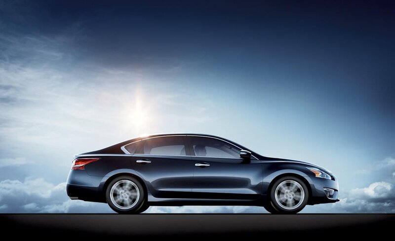 blue sedan car in motion