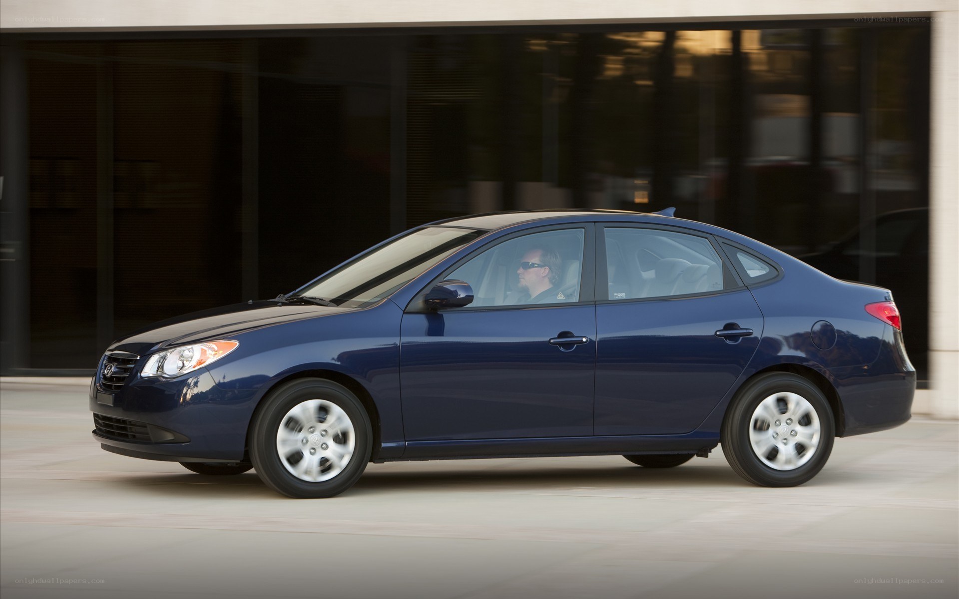 blue sedan car in motion