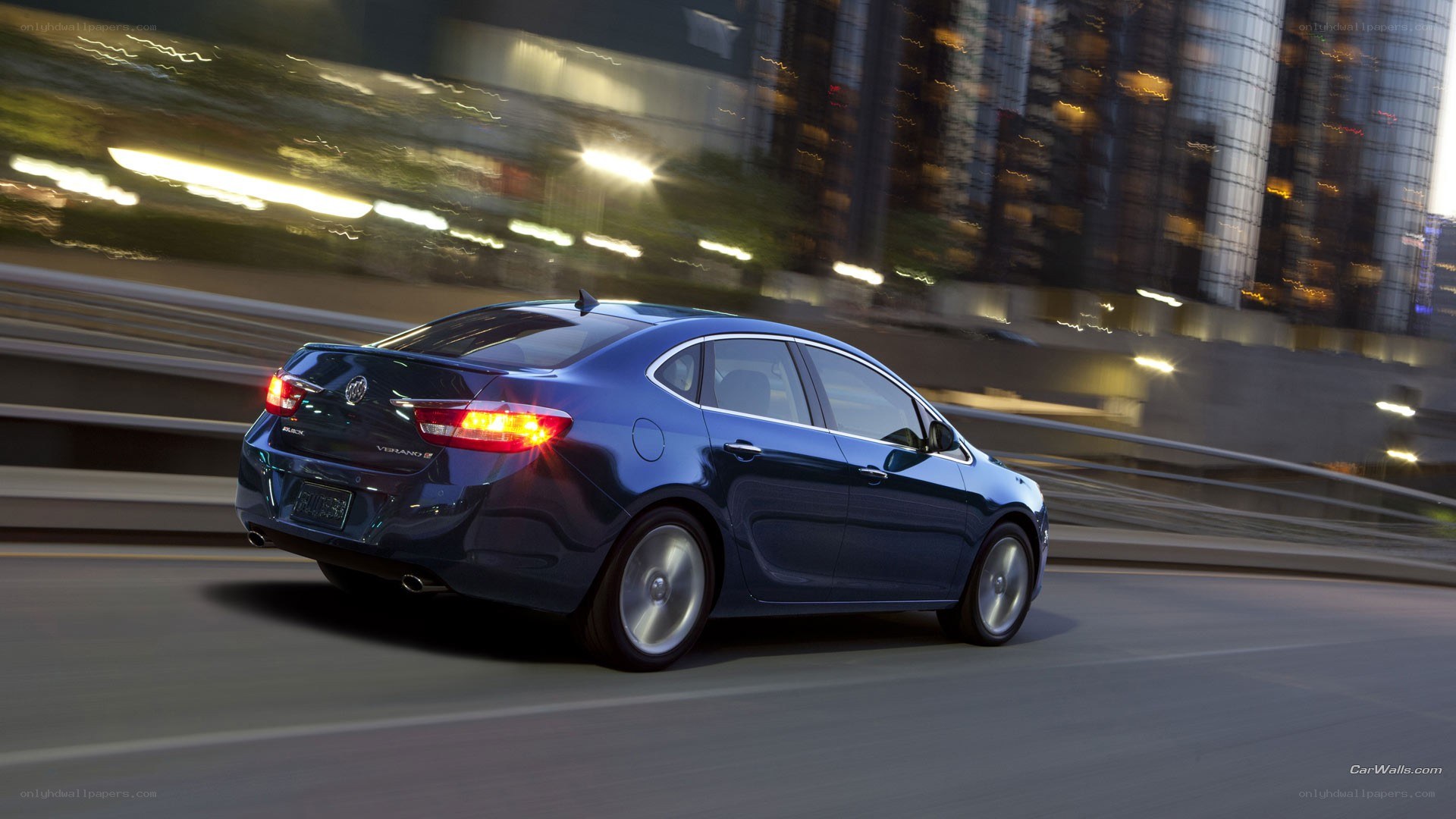 blue sedan driving at night