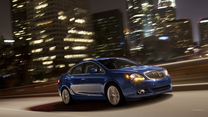 Blue sedan driving at night