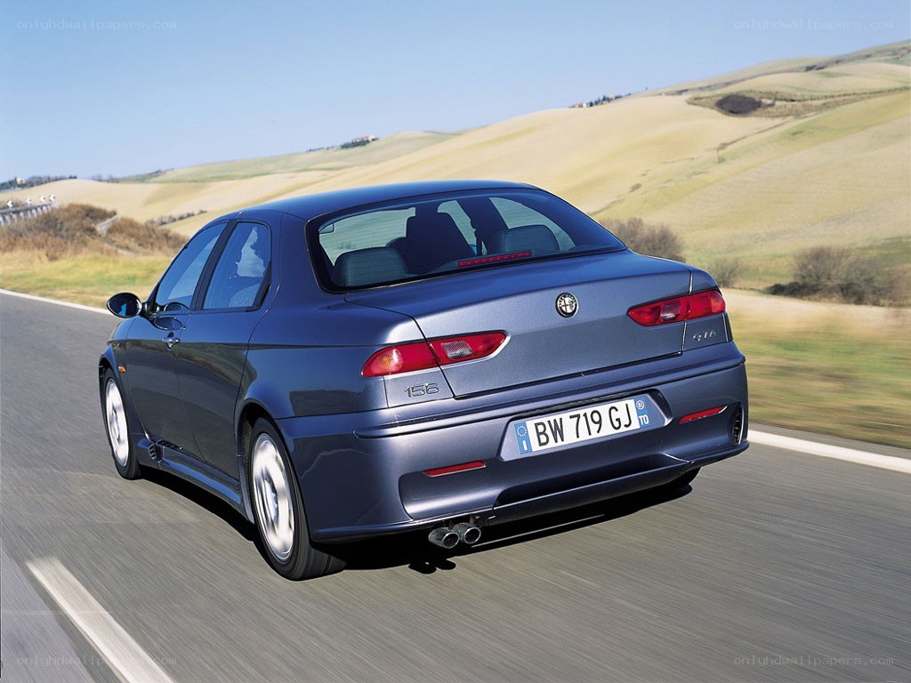 blue sedan driving on road