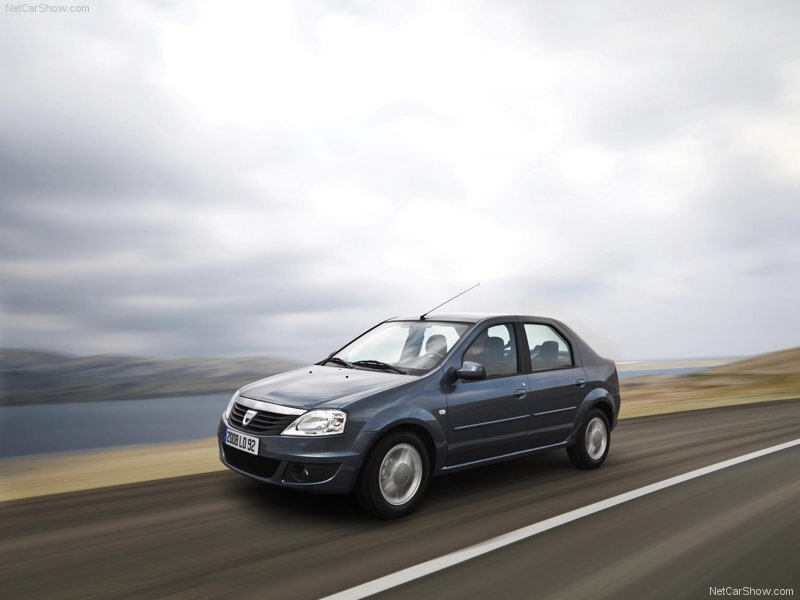 blue sedan driving on road