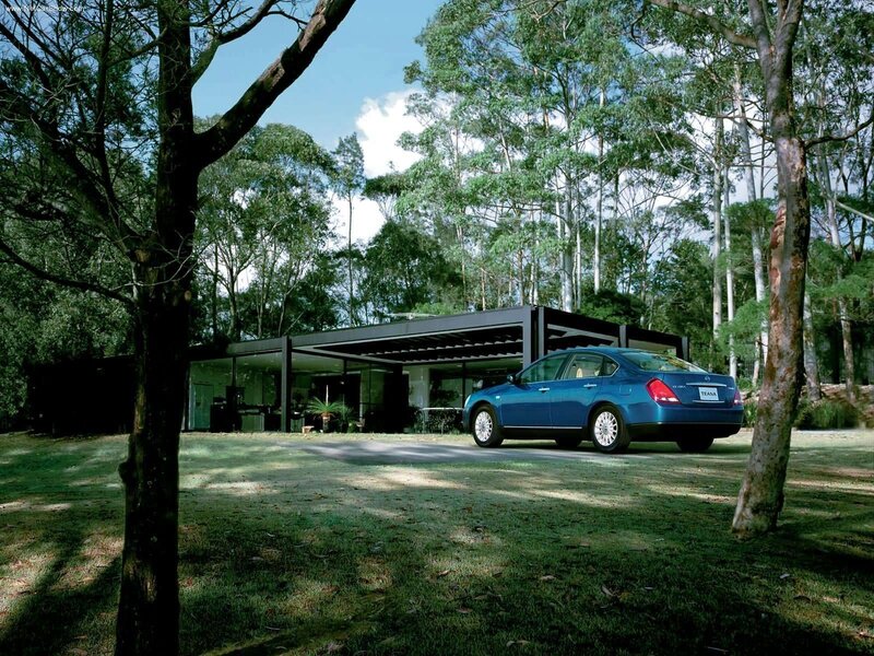 Blue sedan in forest setting