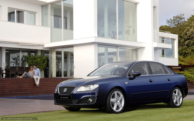 Blue sedan in front of modern house
