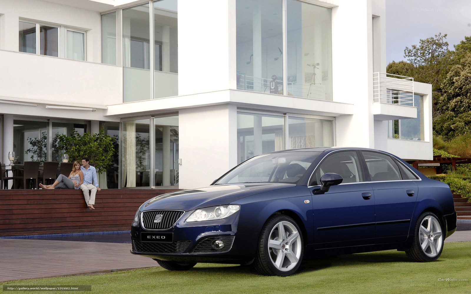 Blue sedan in front of modern house