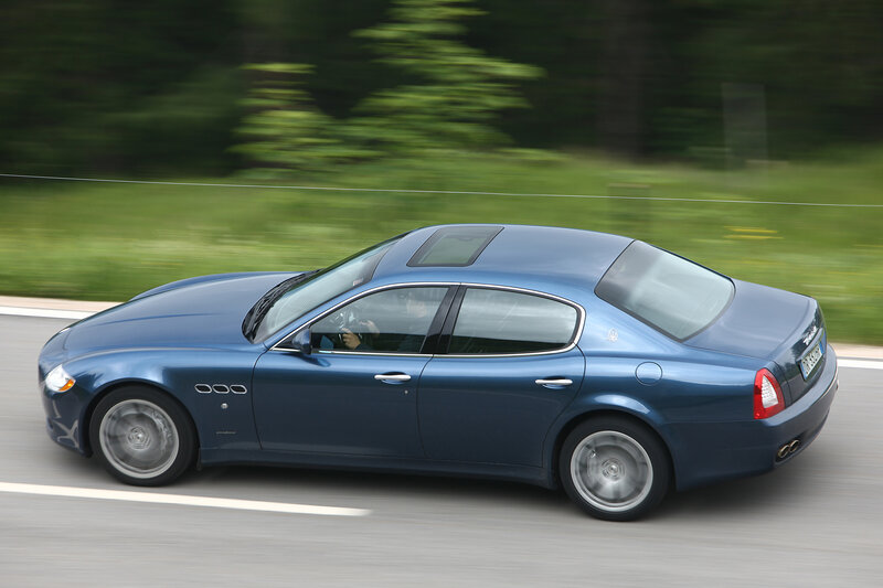 blue sedan in motion