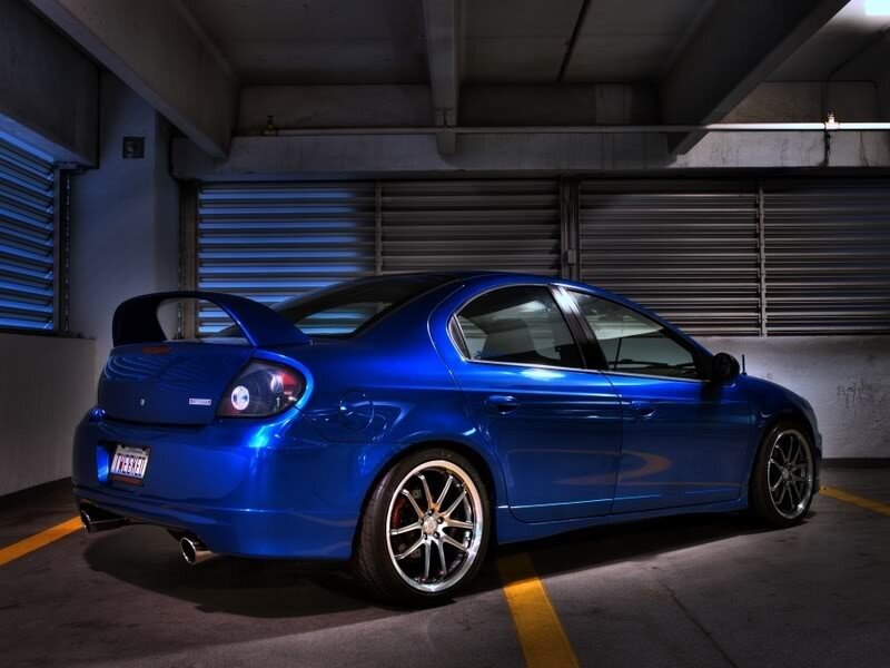 blue sedan in parking garage