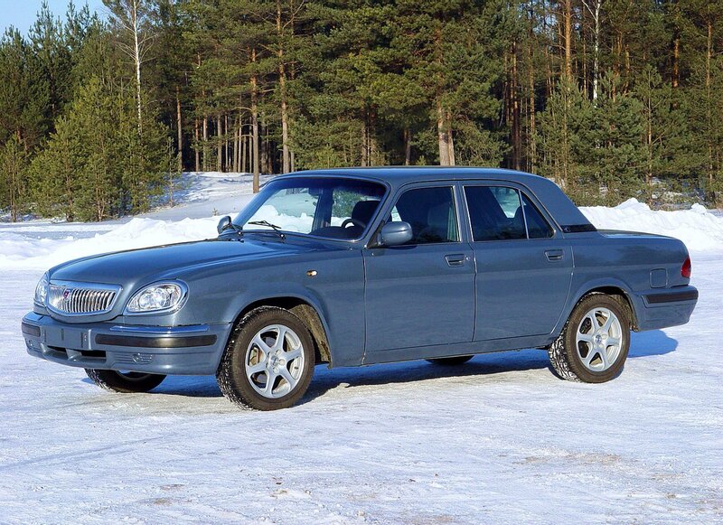 blue sedan in snowy forest