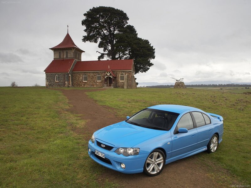 Blue sedan near a church