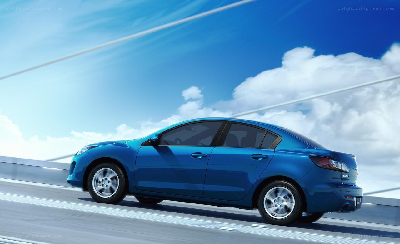 blue sedan on a bridge
