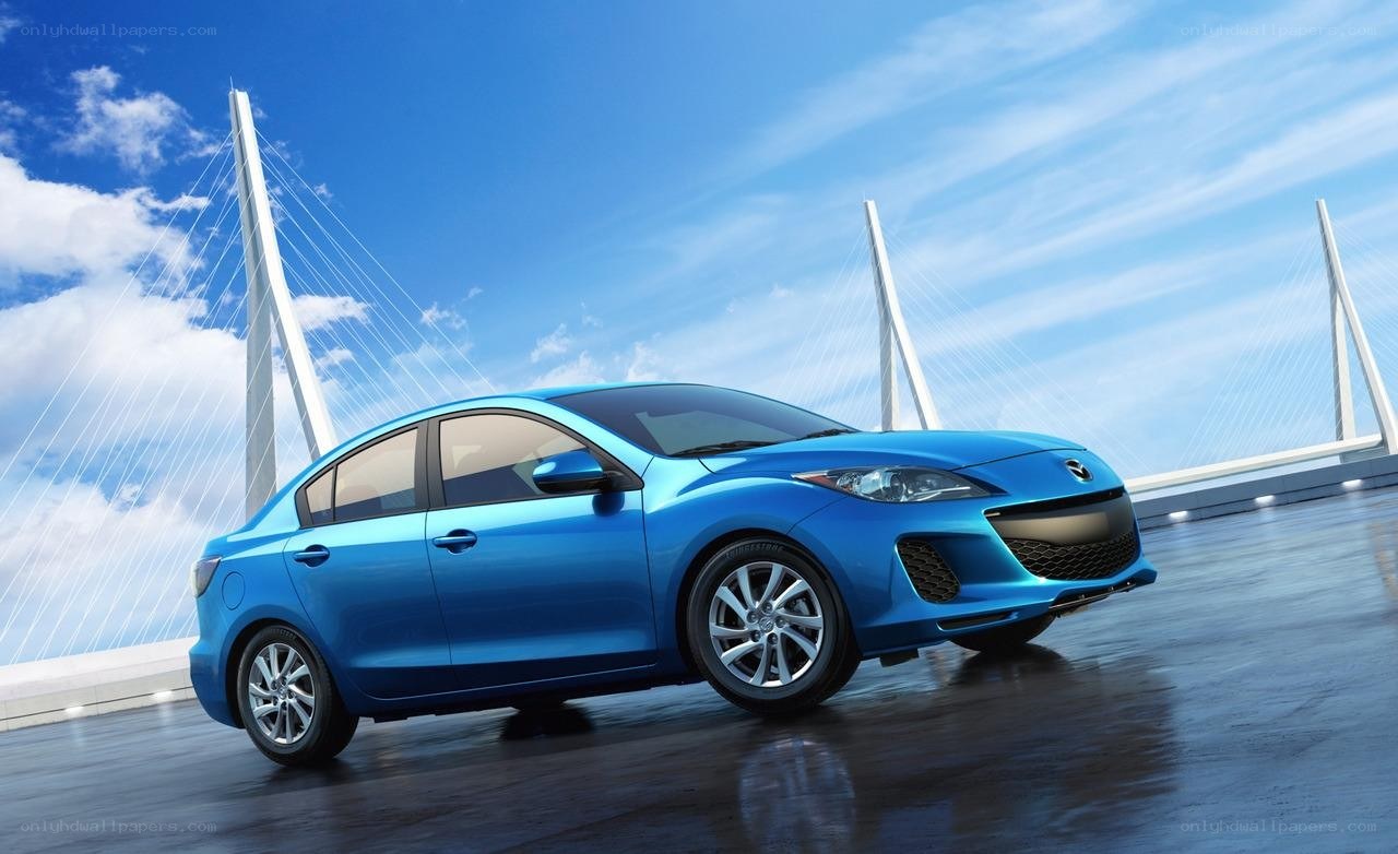 Blue sedan on a bridge