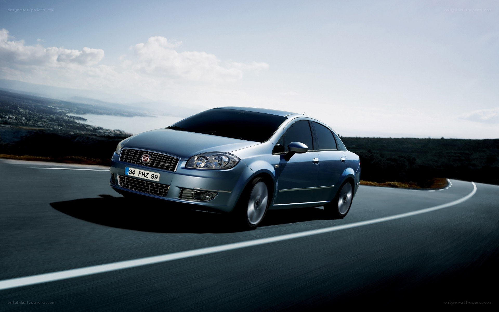 Blue sedan on a winding road