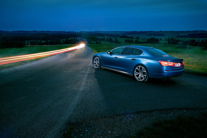 Blue sedan on a winding road
