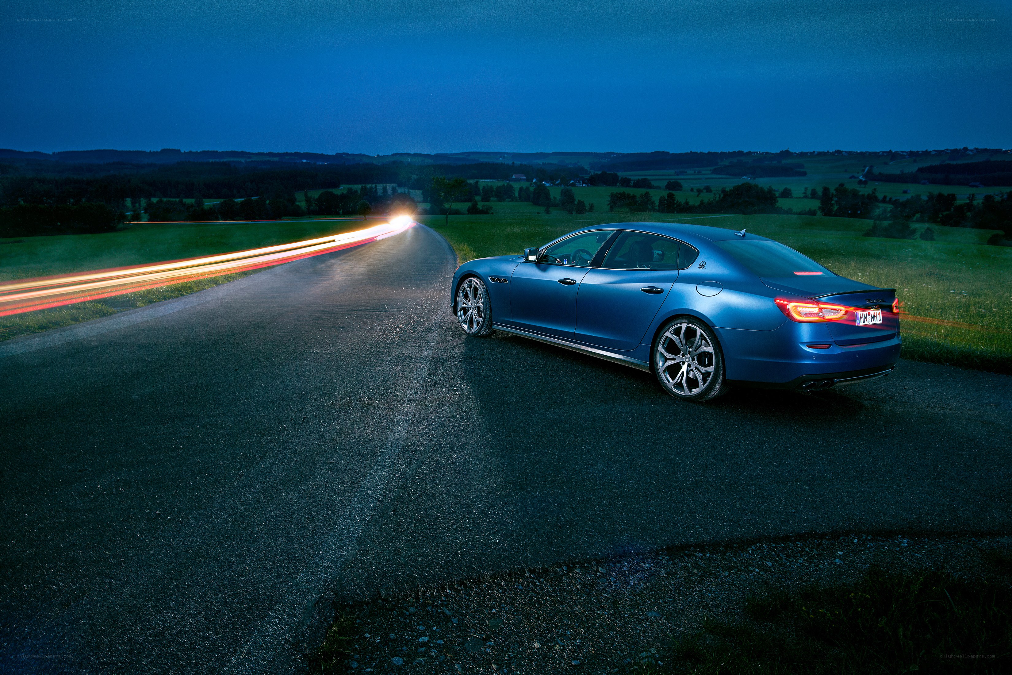 Blue sedan on a winding road