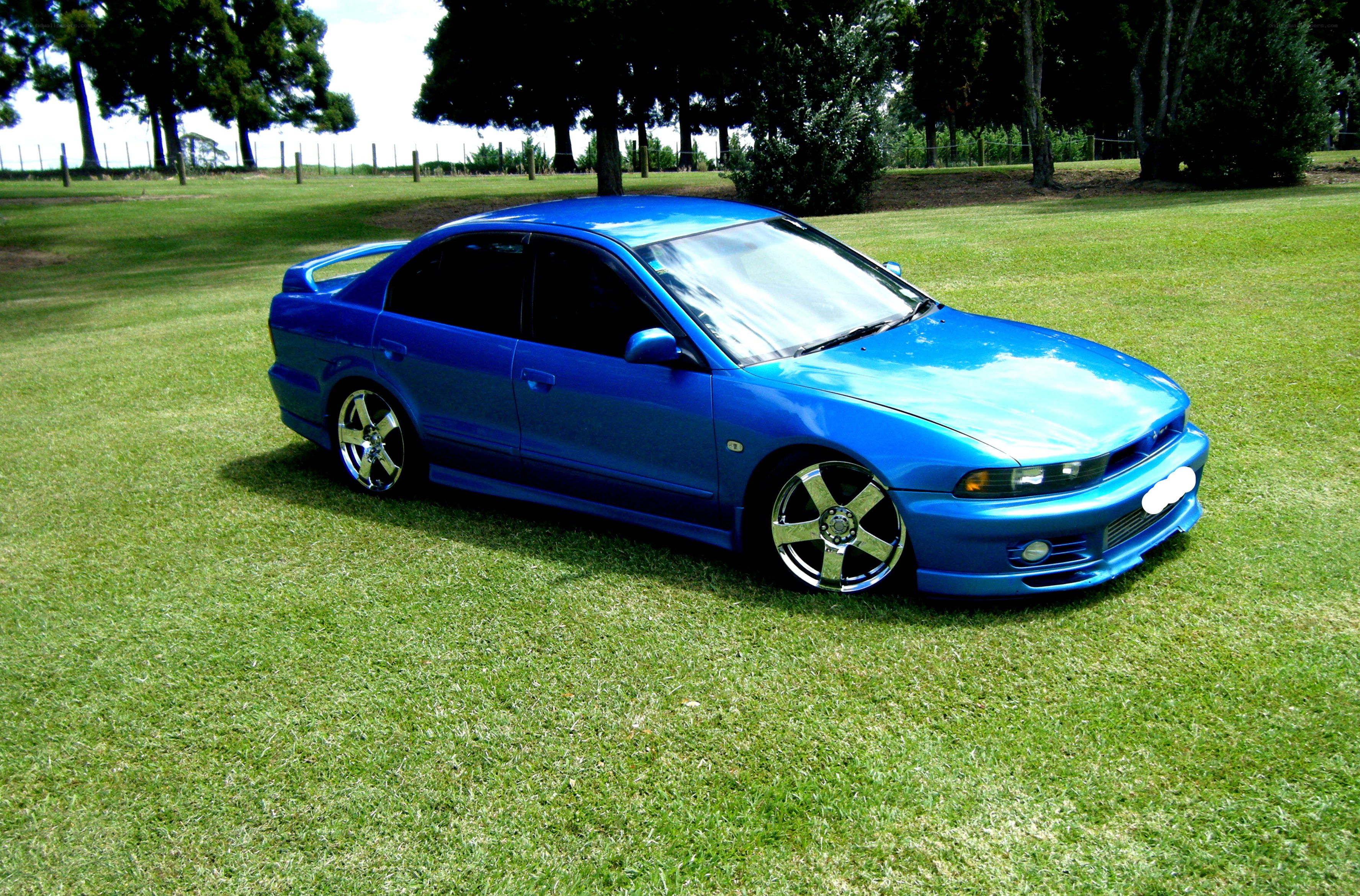 blue sedan on grass