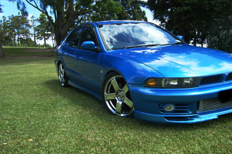 blue sedan on grass