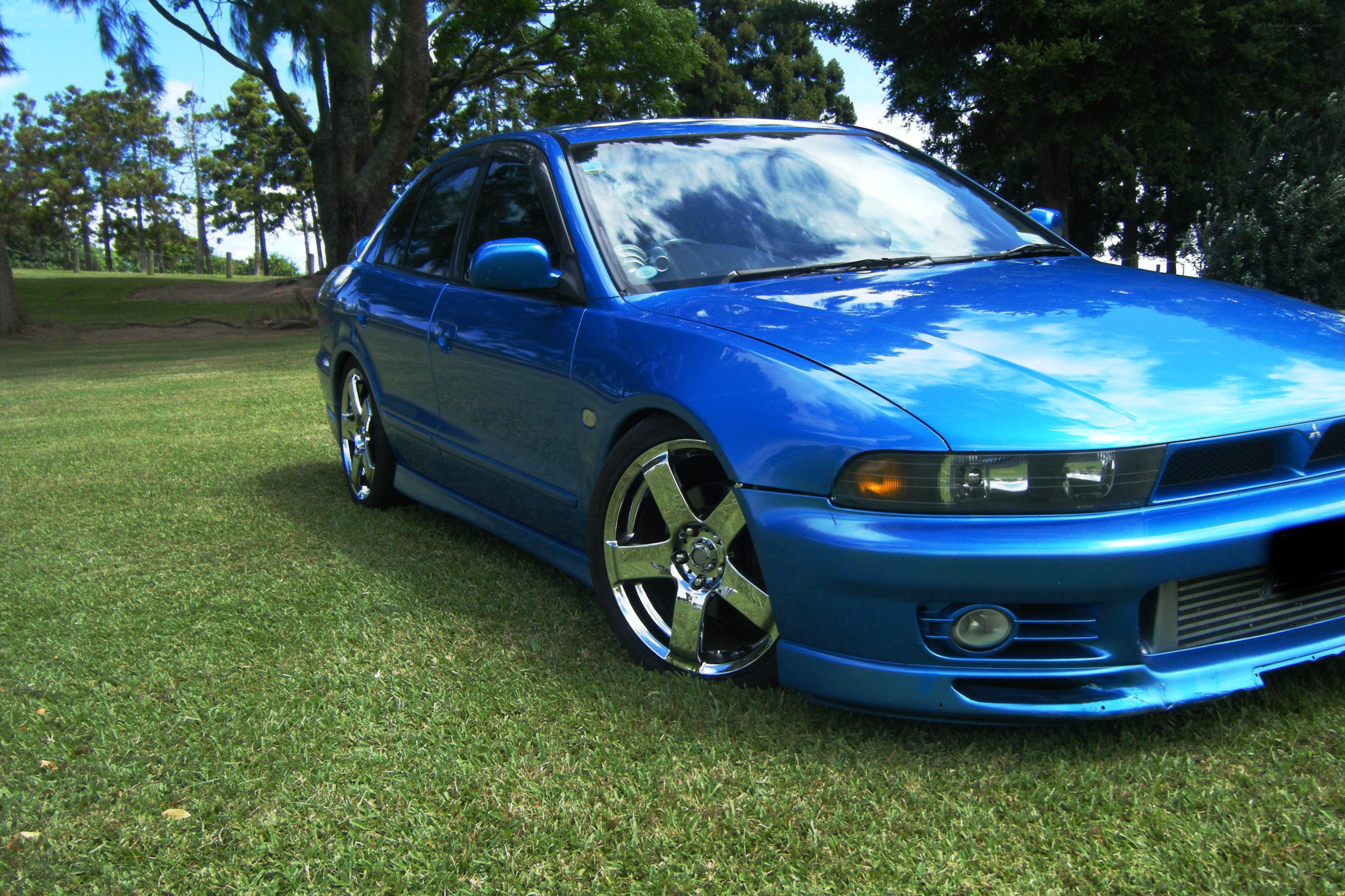 blue sedan on grass
