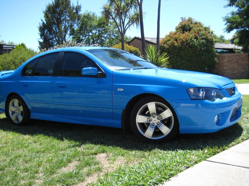 blue sedan on grass