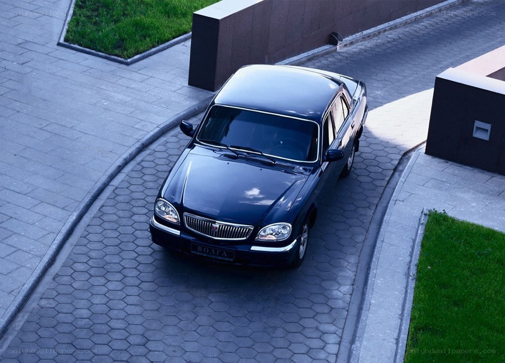 Blue sedan on paved driveway
