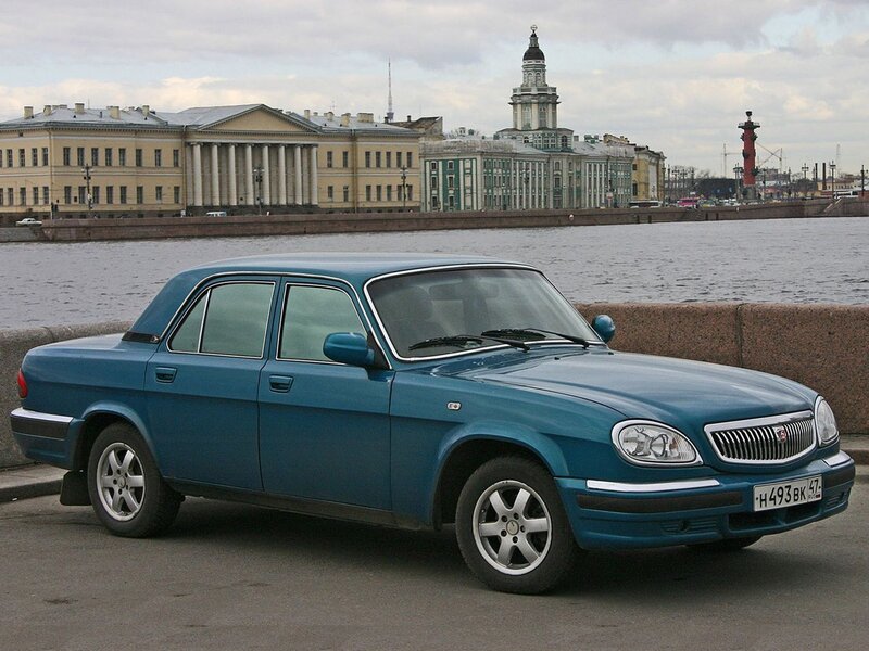 Blue sedan on riverfront
