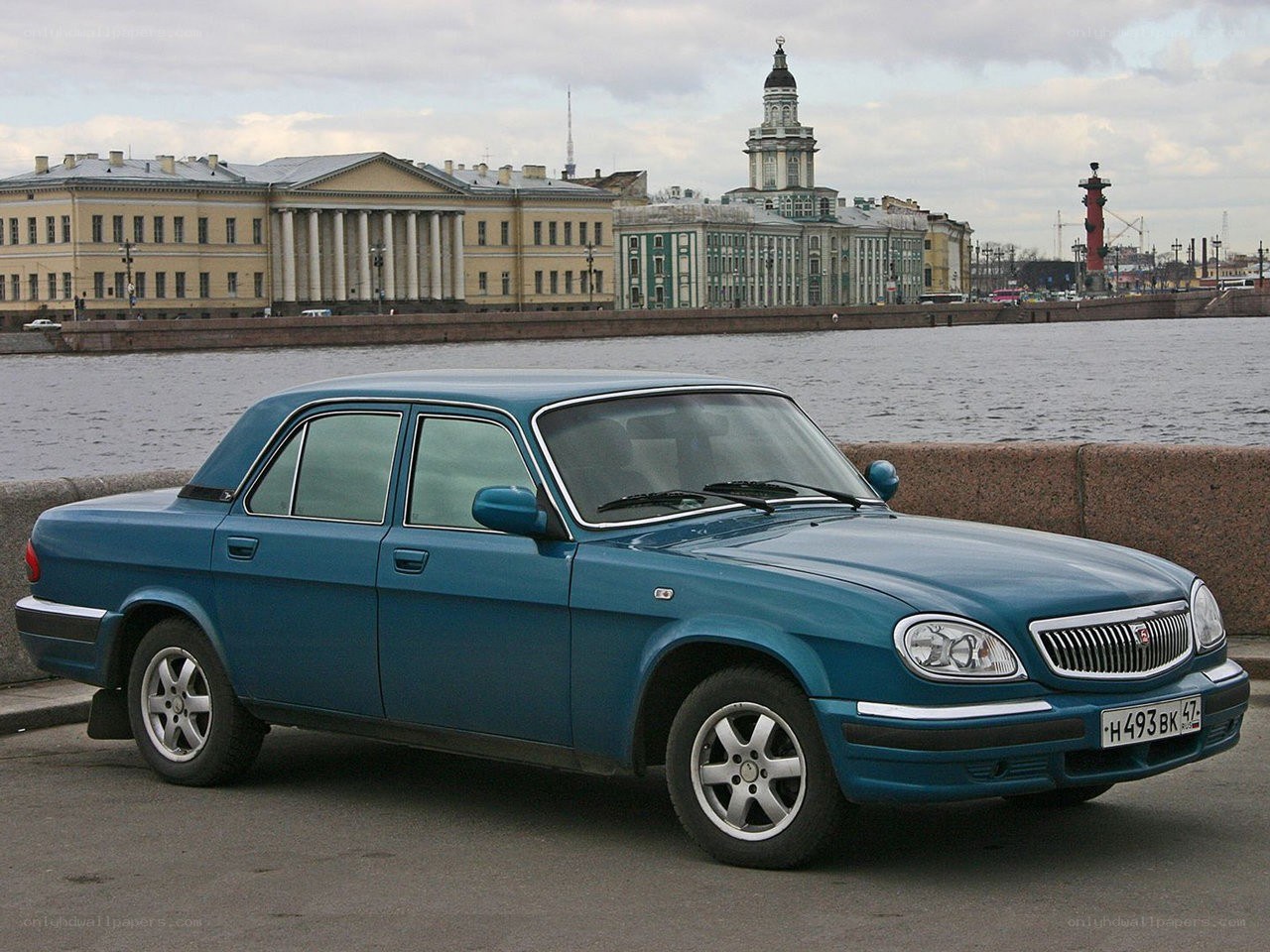 Blue sedan on riverfront