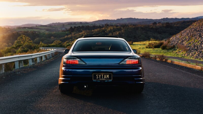 Blue Sedan on Road — Serene