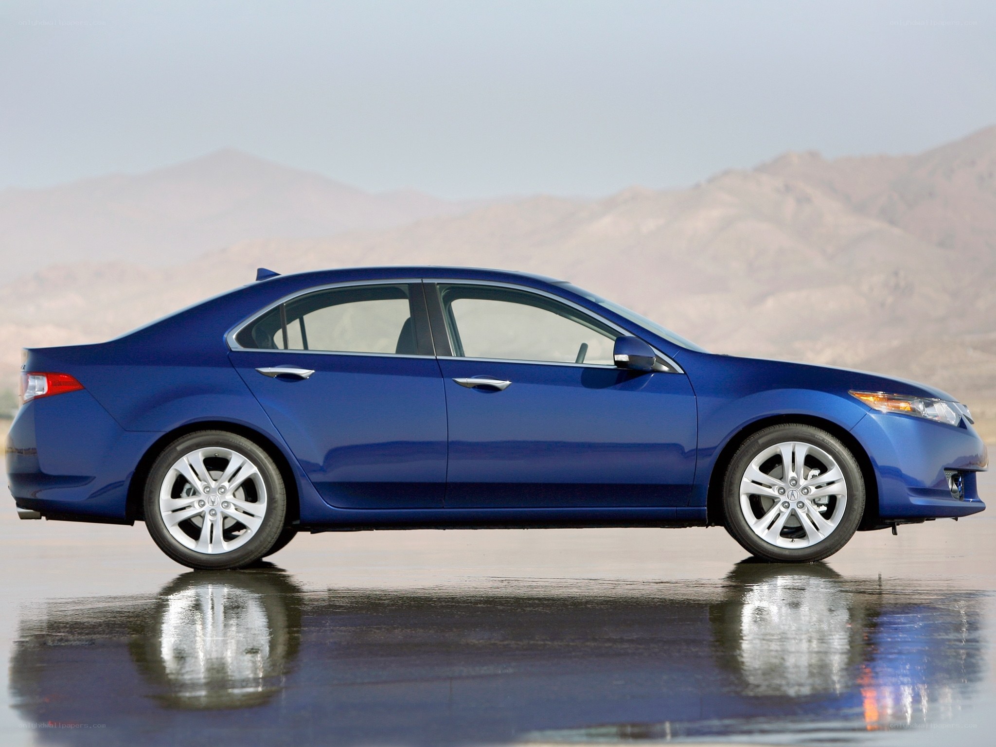 blue sedan on wet surface