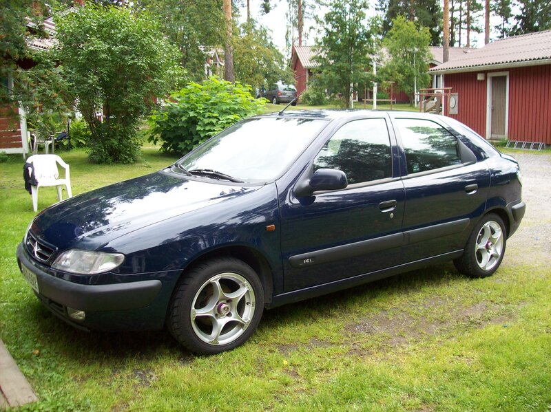 Blue sedan parked on grass