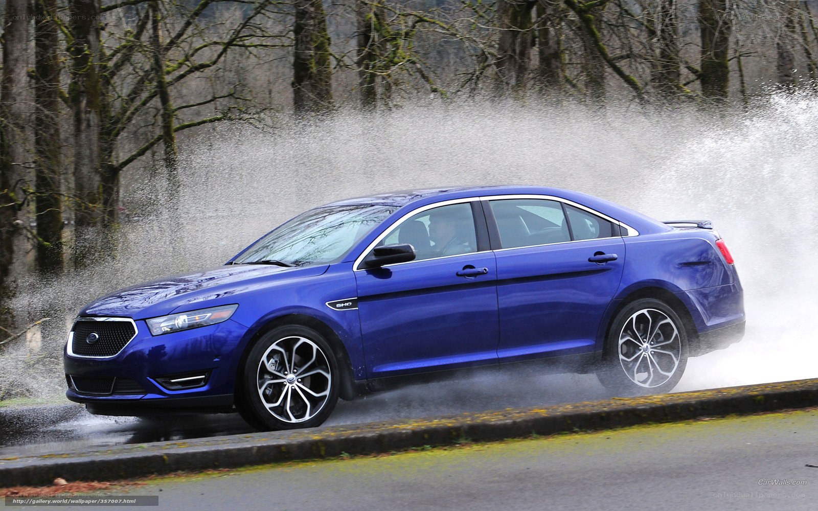 Blue sedan splashing water