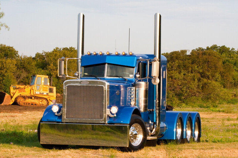 blue semi-truck in field