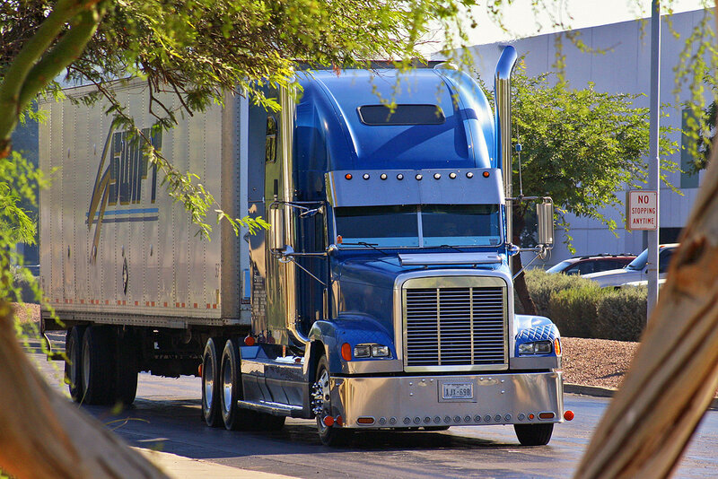 Blue semi-truck on a road