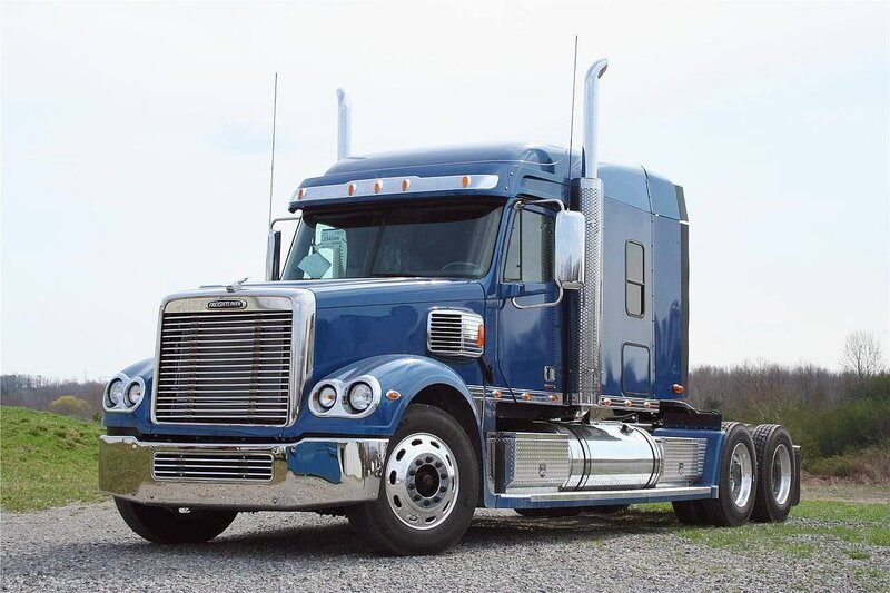 blue semi-truck on gravel