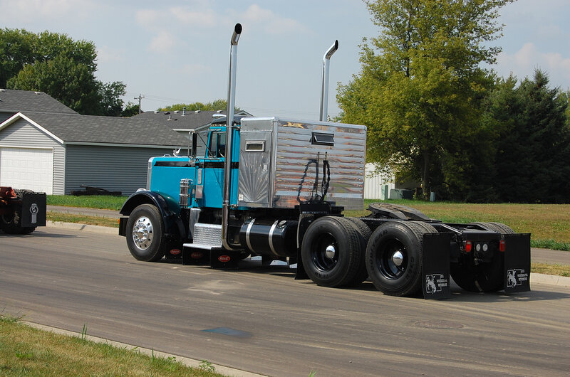 blue semi-truck on road