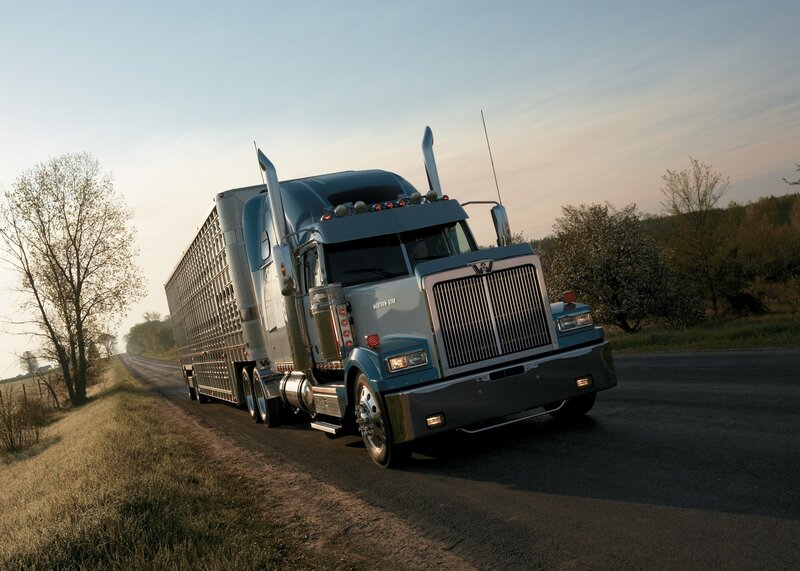 Blue semi-truck on rural road